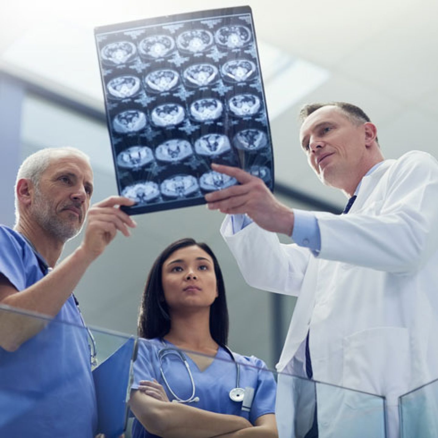 Group of doctors looking at a medical scanner © iStock